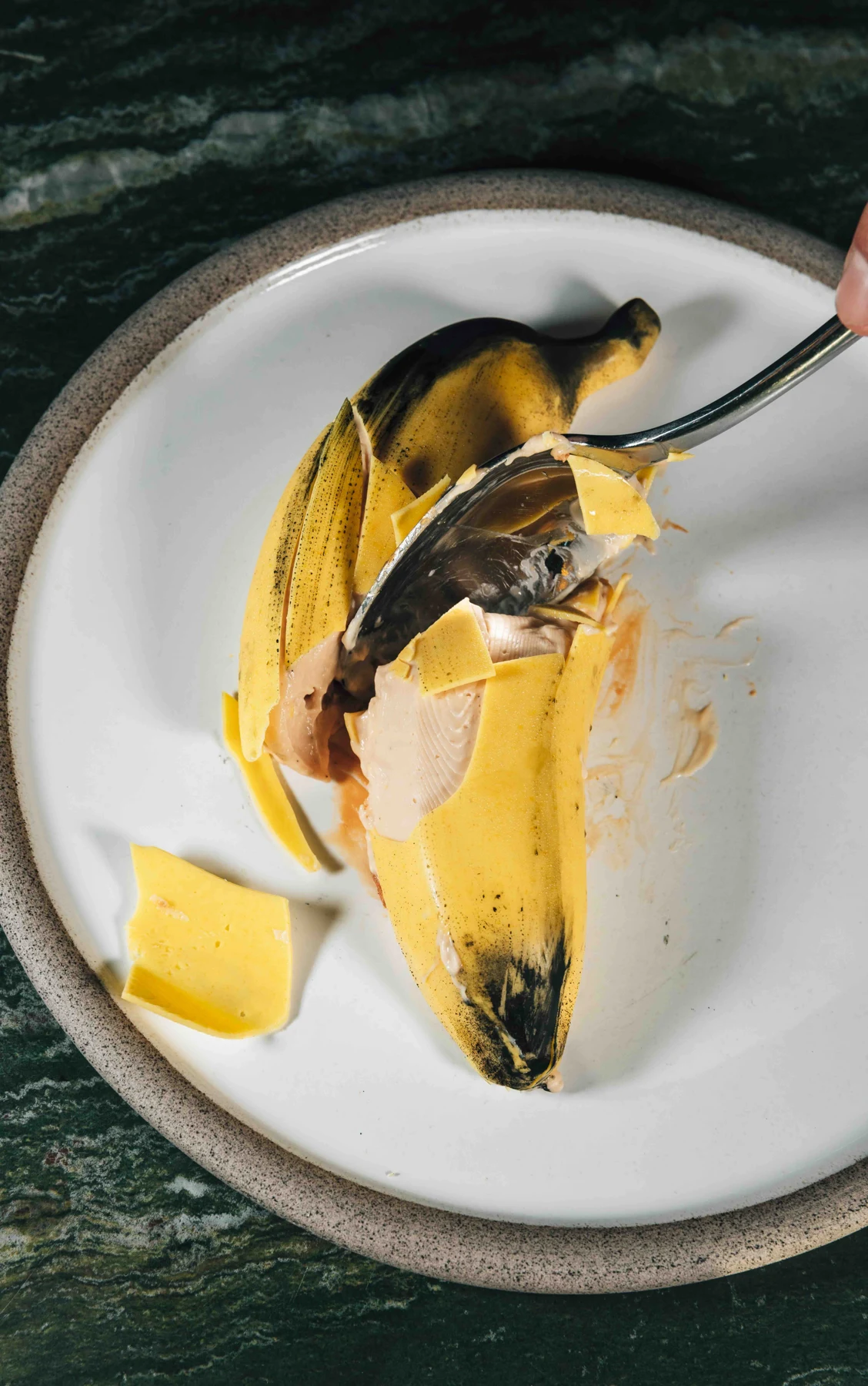 A banana-shaped dessert revealing its filling at UPON Paphos
